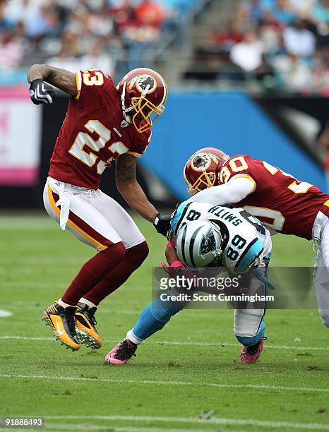 Steve Smith of the Carolina Panthers is tackled by DeAngelo Hall and LaRon Landry of the Washington Redskins at Bank of America Stadium on October...