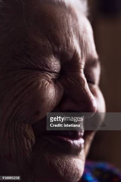 wrinkled face of elderly woman, smiling details - extreme close up face stock pictures, royalty-free photos & images
