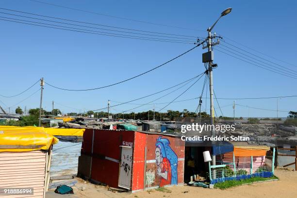 Mural painting and graffitis in the township of Khayelitsha in Cape Town. Khayelitsha is the largest and fastest growing township in Western Cape,...