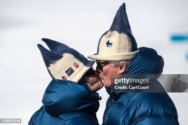 Finnish couple wearing novelty hats share a kiss as they wait for the start of the Cross-Country Skiing Men's 15km Free at Alpensia Cross-Country...