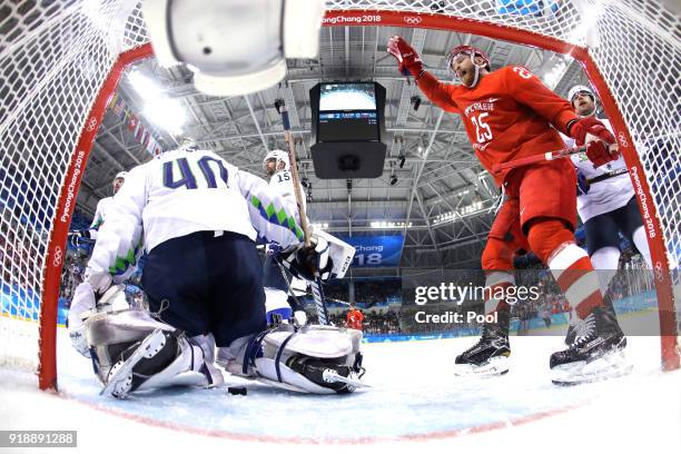 Mikhail Grigorenko of Olympic Athlete from Russia celebrates a goal scored by Alexander Barabanov against Luka Gracnar of Slovenia in the second...