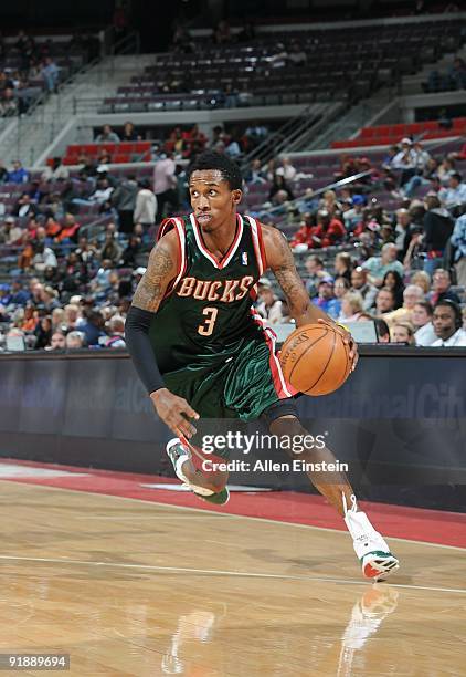 Brandon Jennings of the Milwaukee Bucks moves the ball against the Detroit Pistons during the preseason game at the Palace of Auburn Hills on October...