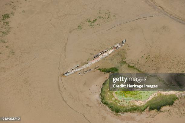 Wrecks at Stoke Saltings, Kent, 2015. Remains of a First World War U-Boat and the sailing boat 'Swale' embedded in mud flats on the River Medway....