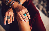 Close-up of bohemian woman's hands with silver jewelry