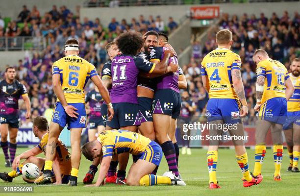 Jesse Bromwich of the Storm is congratulated by his teammates after scoring a try during the World Club Challenge match between the Melbourne Storm...