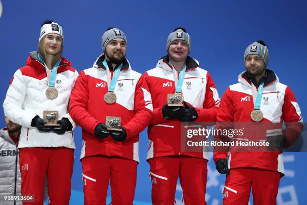 Bronze medalists Madeleine Egle, David Gleirscher, Peter Penz and Georg Fischler of Austria celebrate during the Medal Ceremony for the Luge - Team...