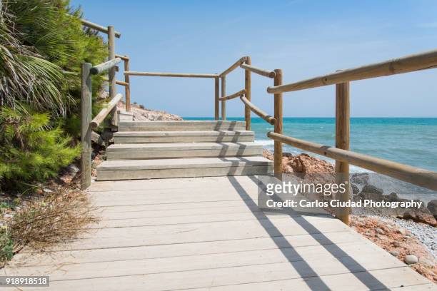 wooden staircase to small beach of the mediterranean sea, peniscola, castellon, spain - costa_del_azahar stock pictures, royalty-free photos & images