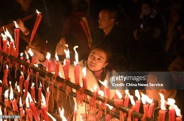 Citizens burn incense sticks to celebrate the Lunar New Year, marking the Year of the Dog, on February 15, 2018 in Mount Emei, Sichuan Province of...