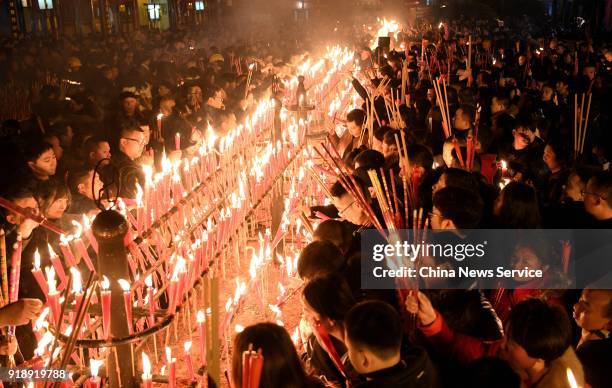 Citizens burn incense sticks to celebrate the Lunar New Year, marking the Year of the Dog, on February 16, 2018 in Mount Emei, Sichuan Province of...