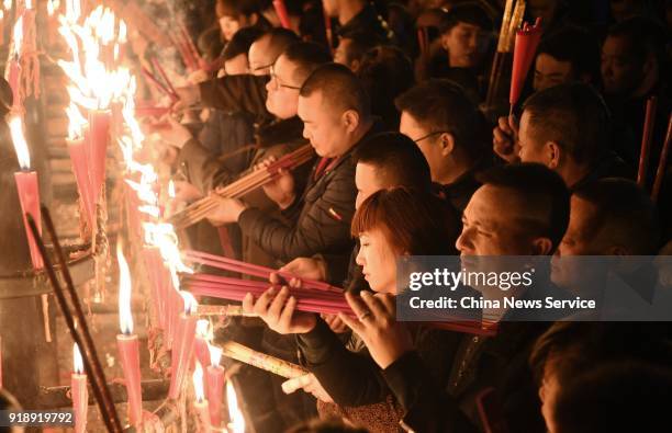 Citizens burn incense sticks to celebrate the Lunar New Year, marking the Year of the Dog, on February 15, 2018 in Mount Emei, Sichuan Province of...