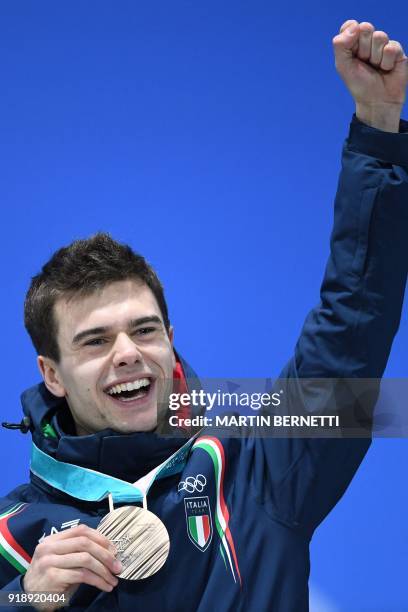 Italy's bronze medallist Nicola Tumolero poses on the podium during the medal ceremony for the men's speed skating 10000m at the Pyeongchang Medals...