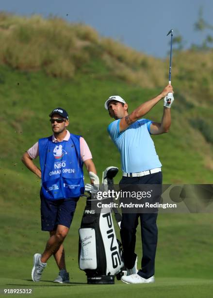 Matthieu Pavon of France plays his second shot on the par five 16th hole during the second round of the NBO Oman Open at Al Mouj Golf on February 16,...