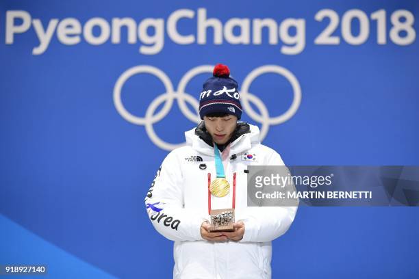 South Korea's gold medallist Yun Sungbin poses on the podium during the medal ceremony for the men's skeleton at the Pyeongchang Medals Plaza during...