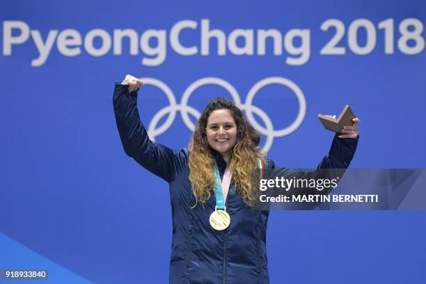 Italy's gold medallist Michela Moioli poses on the podium during the medal ceremony for the women's snowboard cross at the Pyeongchang Medals Plaza...
