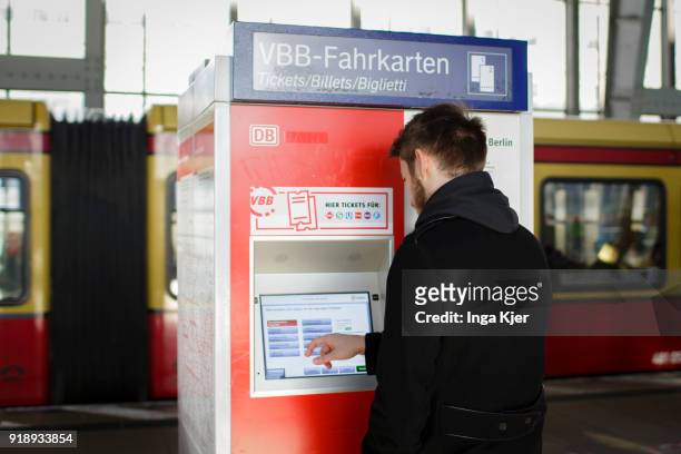 Man buys a ticket at a ticktet machine, on February 14, 2018 in Berlin, Germany.