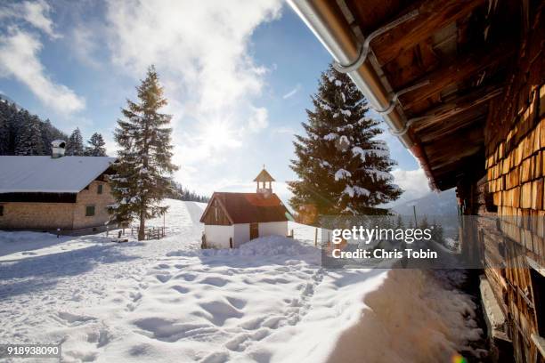 little church in the snowy mountains near a farm - oberstdorf stock pictures, royalty-free photos & images