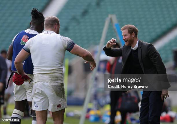 Prince Harry talks with James Haskell and Maro Itoje of England during an England Training Session at Twickenham Stadium on February 16, 2018 in...