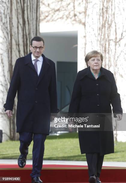 German Chancellor Angela Merkel walks to the honor guard with new Polish Prime Minister Mateusz Morawiecki upon Morawiecki's arrival at the...