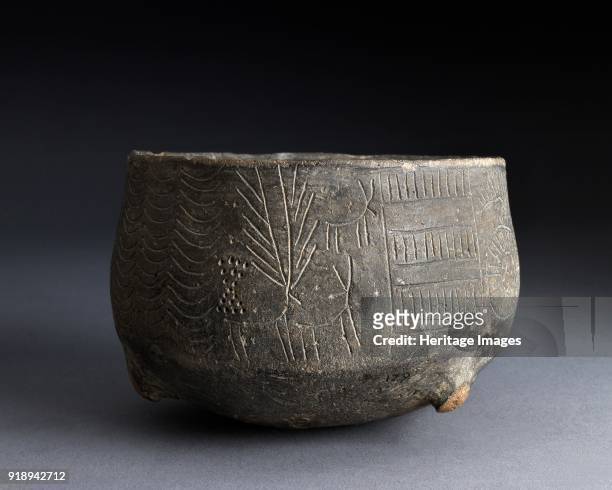 Pot, Chalcolithic Period . Grit tempered pot with incised decoration of stag and hinds. Rounded base; four short legs; one central internal stump,...