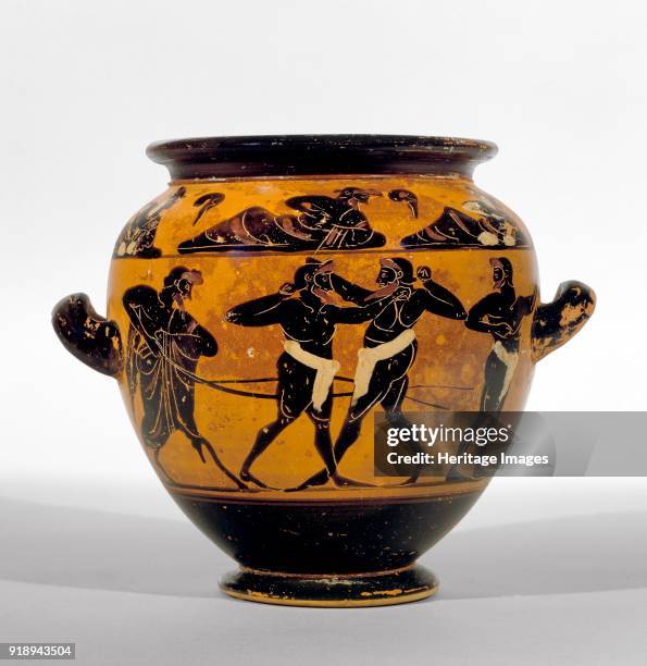 Athenian black-figure stamnos depicting athletes around belly of the vase and a symposium of men and women around the shoulder, 520-500 BC. Athenian...