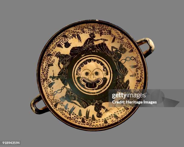 Athenian black-figure footed cup with depiction of symposium around a central Gorgo head on the inside, c500 BC. Athenian black-figure cup;...