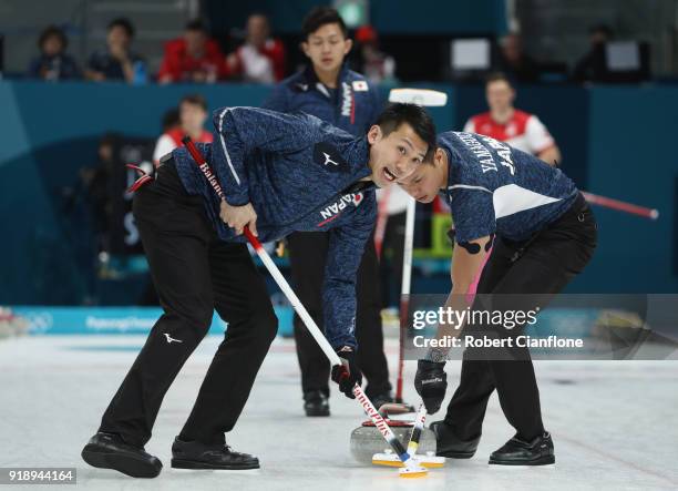 Tetsuro Shimizu and Tsuyoshi Yamaguchi of Japan delivers a stone in the Curling Men's Round Robin Session 5 held at Gangneung Curling Centre on...