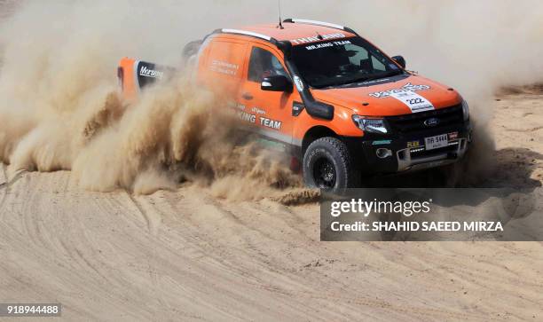 Pakistani driver powers his vehicle during the Cholistan Desert Jeep Rally in Derawar on February 16, 2018. - More than 100 drivers have registered...