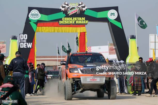 Pakistani jeep driver powers his vehicle during the Cholistan Desert Jeep Rally in Derawar on February 16, 2018. - More than 100 drivers have...