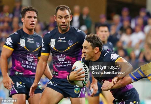 Billy Slater of the Storm runs with the ball as Cameron Smith and Brodie Croft look on during the World Club Challenge match between the Melbourne...