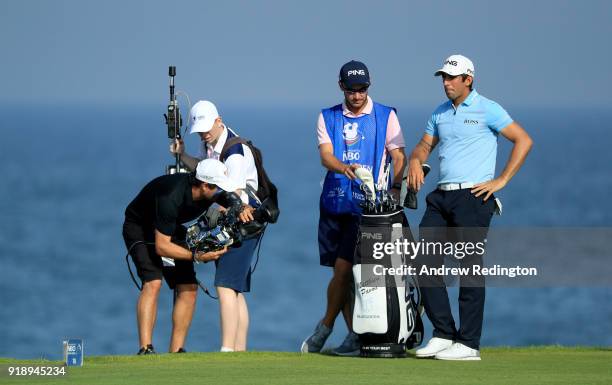 Matthieu Pavon of France gets some attention from a tv cameraman the par for 18th hole during the second round of the NBO Oman Open at Al Mouj Golf...