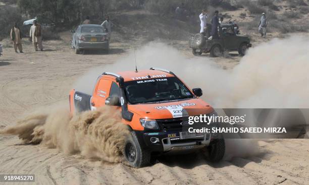 Pakistani driver powers his vehicle during the Cholistan Desert Jeep Rally in Derawar on February 16, 2018. - More than 100 drivers have registered...