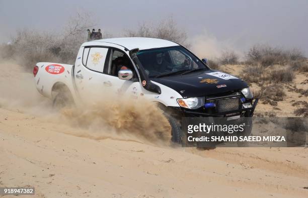 Pakistani jeep driver powers during the Desert Jeep Rally in the Cholistan Desert in Drawar on February 16, 2018. - More than 100 drivers have...