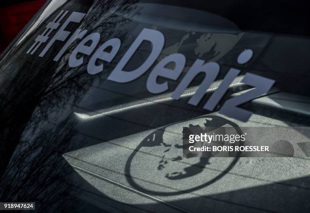 Sticker on a car window depicting German-Turkish journalist Deniz Yucel casts a shadow in the car on February 16, 2018 in Yucel's home town...