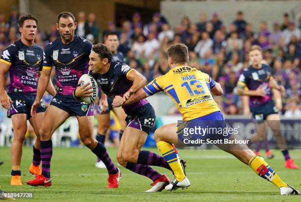 Billy Slater of the Storm runs with the ball as Cameron Smith and Brodie Croft look on during the World Club Challenge match between the Melbourne...