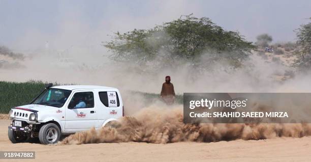 Pakistani driver powers his vehicle during the Cholistan Desert Jeep Rally in Derawar on February 16, 2018. - More than 100 drivers have registered...