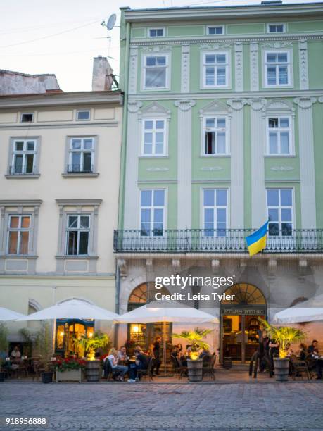 Tourists on Rynok or Market Square, the main square in the old town of Lviv, in Ukraine. Its well preserved architecture, which blends Central and...