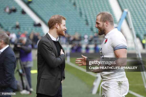 Britain's Prince Harry talks with England rugby player James Haskell as he attends the England rugby team open training session at Twickenham Stadium...