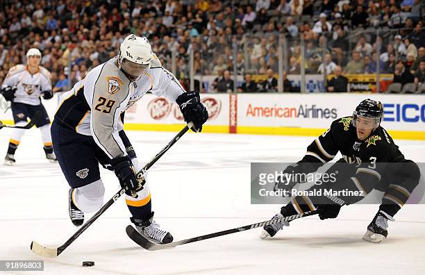 Right wing Joel Ward of the Nashville Predators skates the puck past Stephane Robidas of the Dallas Stars at American Airlines Center on October 14,...