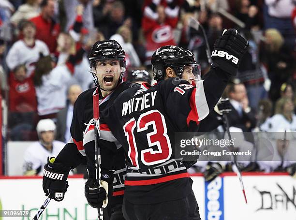 Ray Whitney of the Carolina Hurricanes scores and celebrates with teammate Tuomo Ruutu during a NHL game against the Pittsburgh Penguins on October...