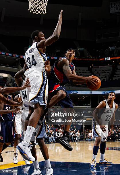Jeff Teague of the Atlanta Hawks shoots a layup against Hasheem Thabeet of the Memphis Grizzlies on October 14, 2009 at FedExForum in Memphis,...