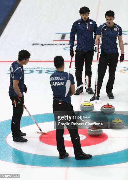 Tetsuro Shimizu, Yusuke Morozumi, Kosuke Morozumi and Tsuyoshi Yamaguchi of Japan talk during the Curling Men's Round Robin Session 5 held at...