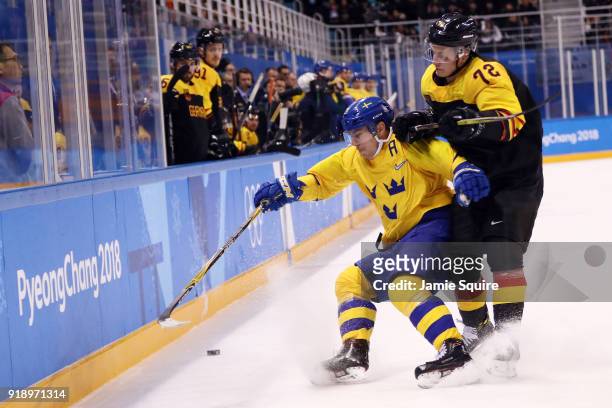 Marcus Kink of Germany handles the puck against Sweden during the Men's Ice Hockey Preliminary Round Group C game at Kwandong Hockey Centre on...