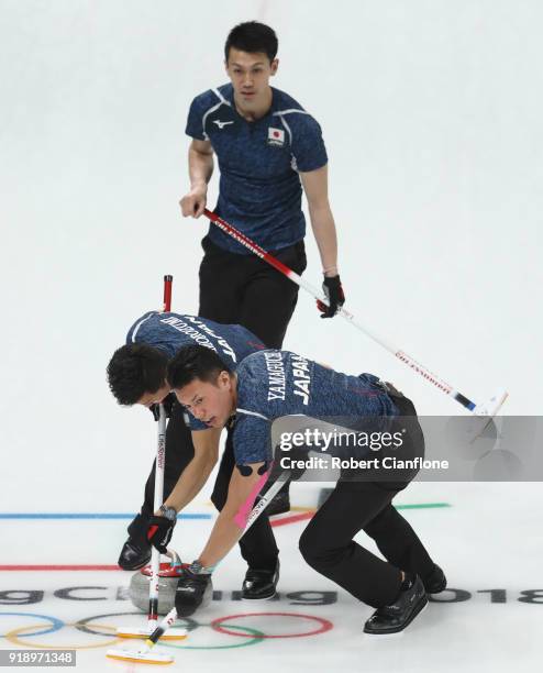 Tetsuro Shimizu and Tsuyoshi Yamaguchi of Japan delivers a stone in the Curling Men's Round Robin Session 5 held at Gangneung Curling Centre on...