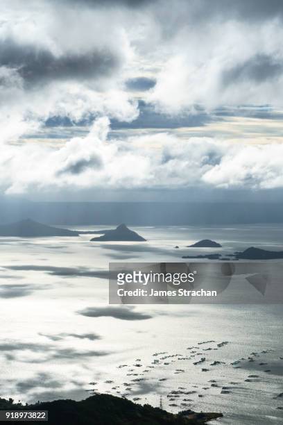 volcanic peaks in early morning light spread across lake taal, itself the result of eruptions over 100,000 years ago, tagaytay, luzon island, philippines - tagaytay stock pictures, royalty-free photos & images