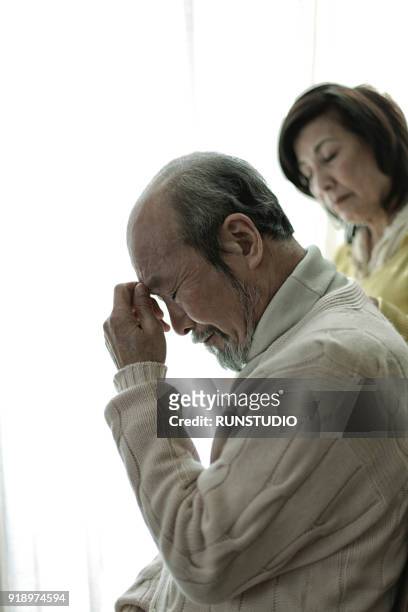 wife comforting husband - the japanese wife foto e immagini stock