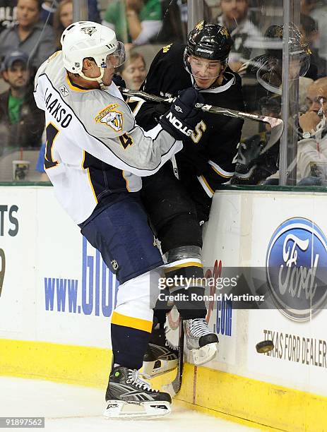 Defenseman Teemu Laakso of the Nashville Predators checks Tom Wandell of the Dallas Stars at American Airlines Center on October 14, 2009 in Dallas,...