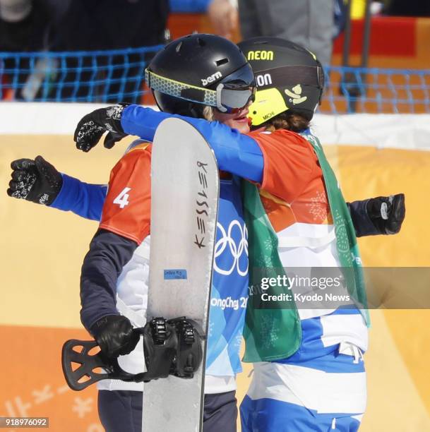 Michela Moioli of Italy and Lindsey Jacobellis of the United States hug each other after their race in the women's snowboard cross at the Pyeongchang...