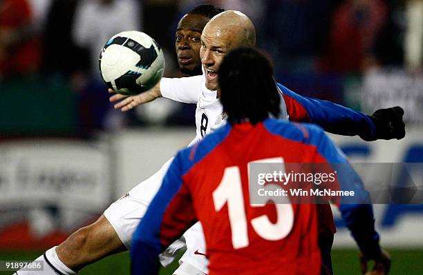 Conor Casey of the United States battles Junior Diaz of Costa Rica during their FIFA 2010 World Cup Qualifier at RFK stadium on October 14, 2009 in...