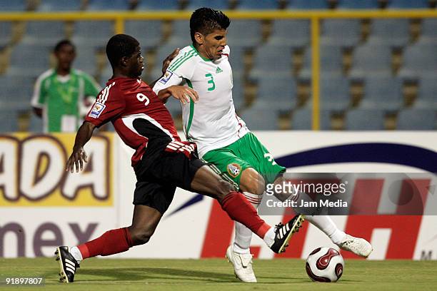 Hector Hughton of Trinidad and Tobago fights for the ball with Carlos Salcido of Mexico during their match as part of the 2010 FIFA World Cup...