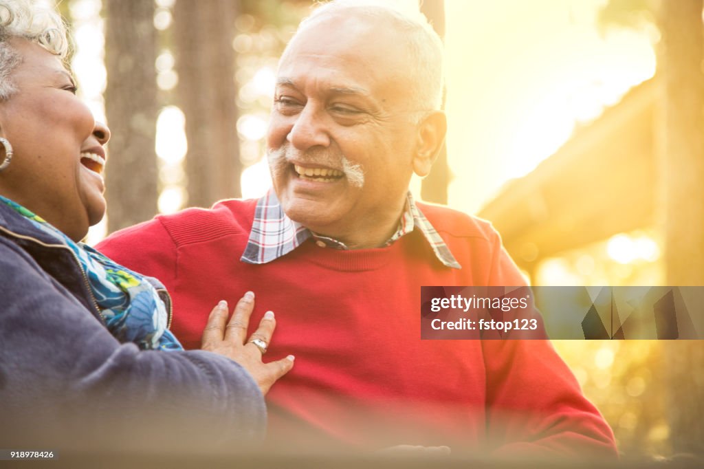 Active senior adult couple enjoy outdoor park.